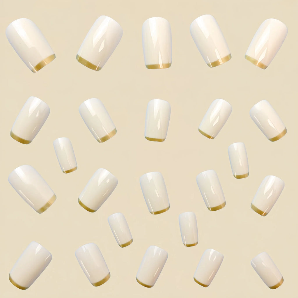Mid-length European square nail art patch with white French tip and golden edge on a natural nail