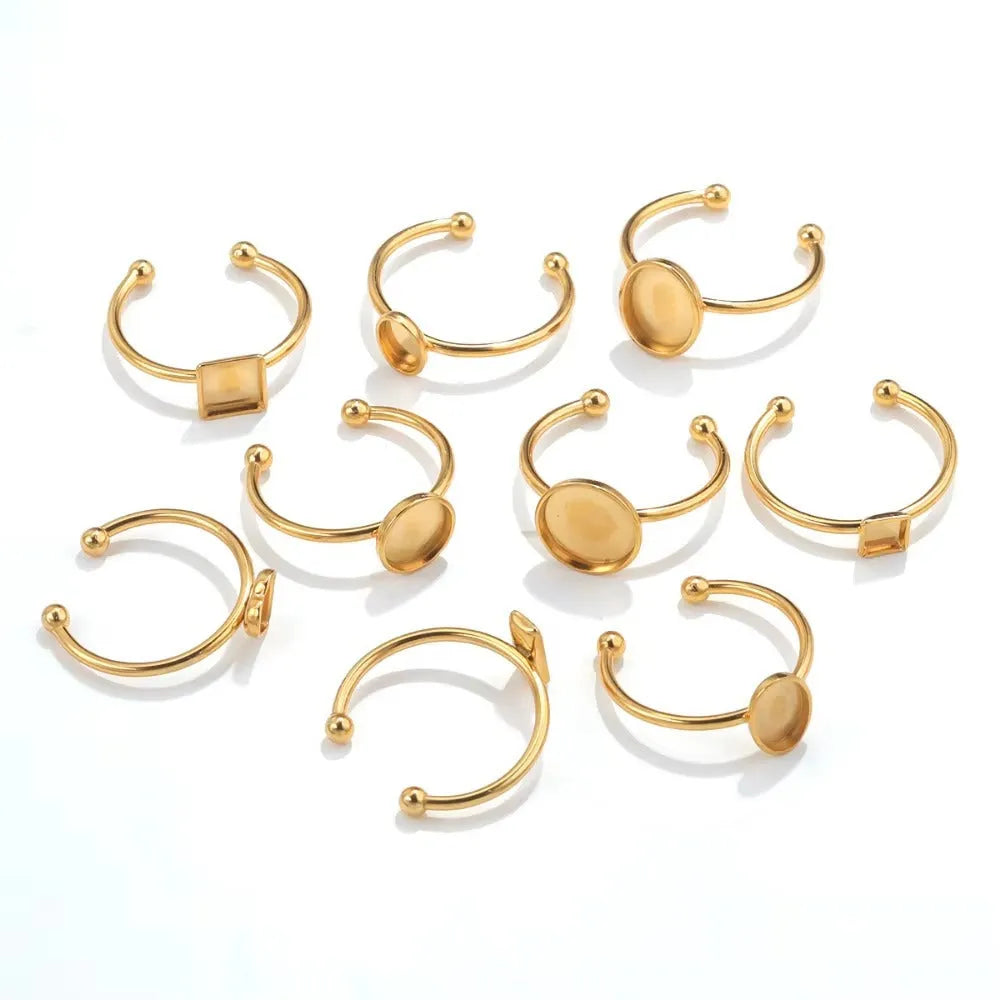 Assortment of golden electroplated stainless steel ring settings and DIY jewellery components in various shapes.