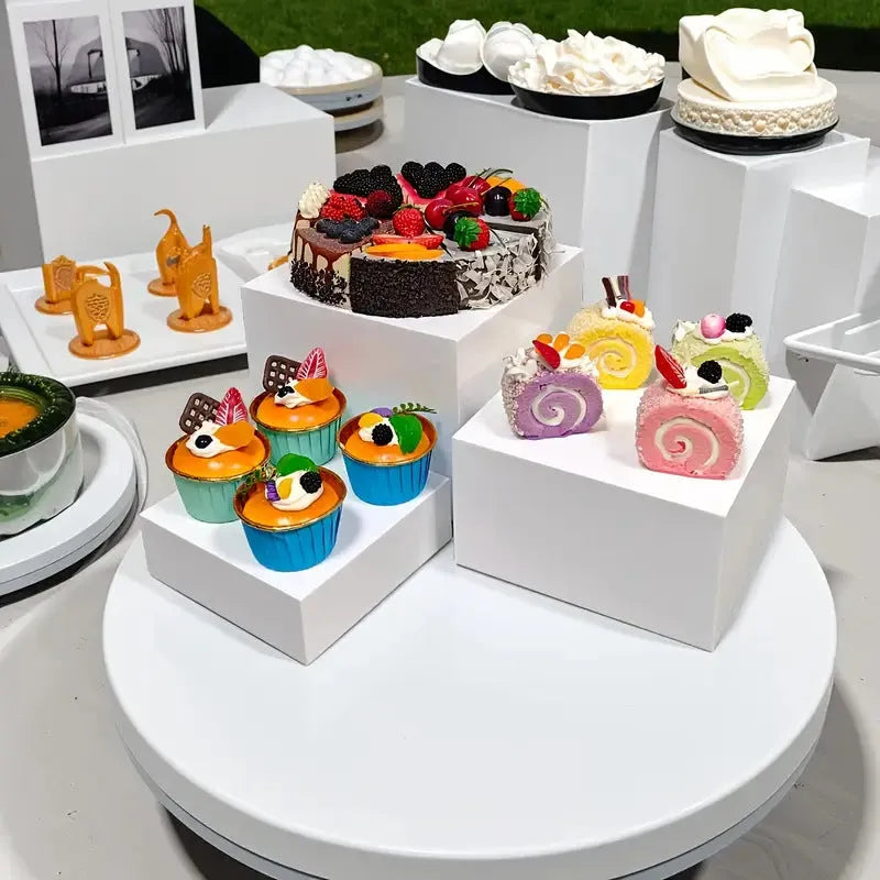White plastic six-piece stacking dessert table display stand set for tiered bakery presentation