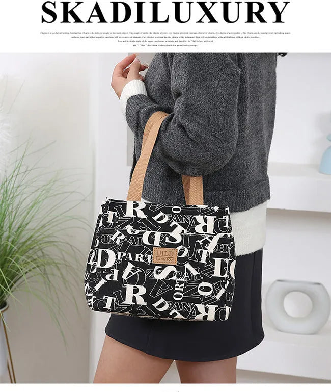 Women's printed canvas tote bag with aluminium frame showing horizontal square shape and floral pattern design