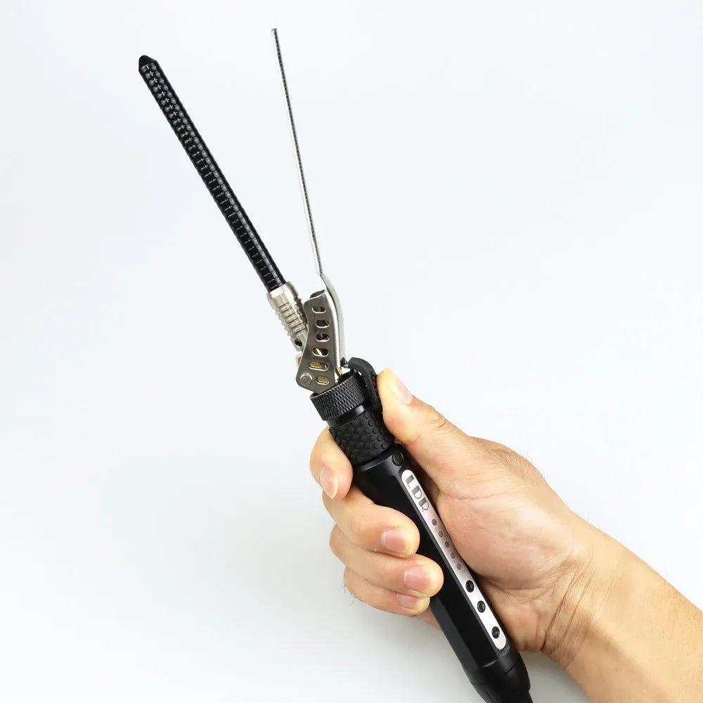Black 7mm small hair curler with rotatable clip on a flat surface