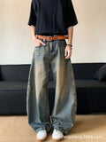 Man wearing retro blue distressed wide-leg denim trousers with a slimming fit.