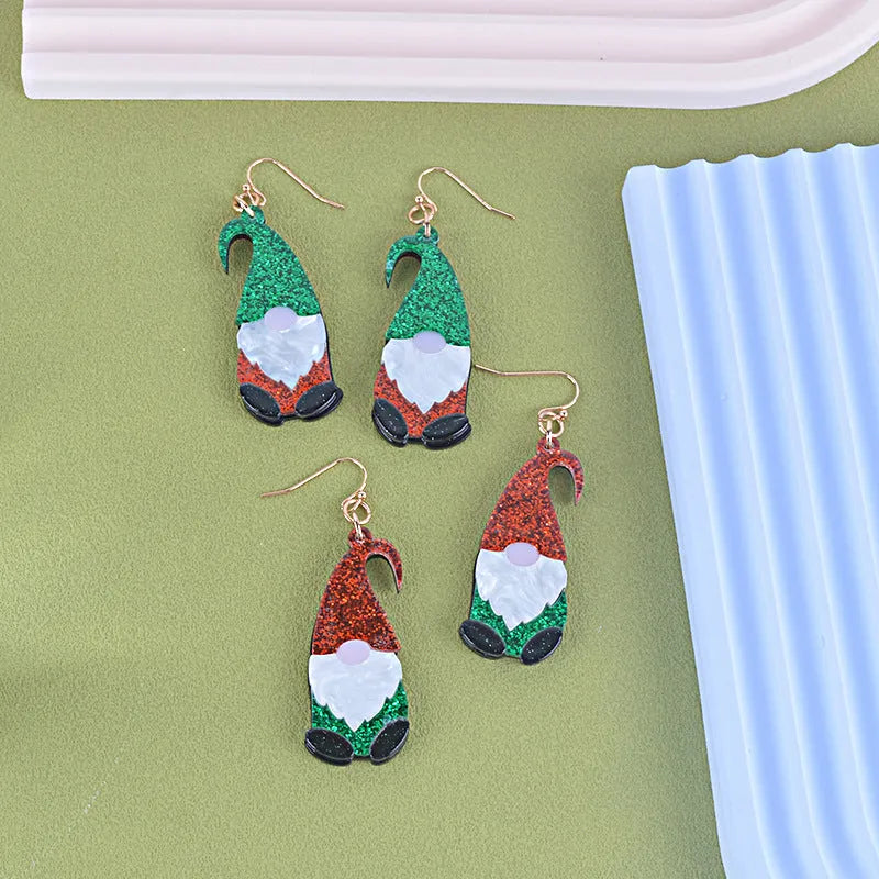 Pair of cartoon Santa Claus acrylic earrings in red and green hat style.
