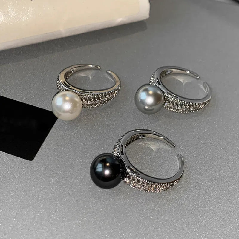 Geometric copper open band ring for women with a black pearl and adjustable opening.