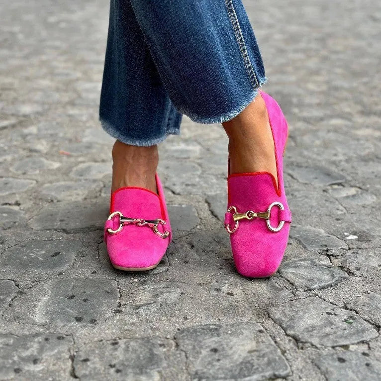 Green suede women's loafers with a round toe and silver metal fastener on a flat rubber sole.