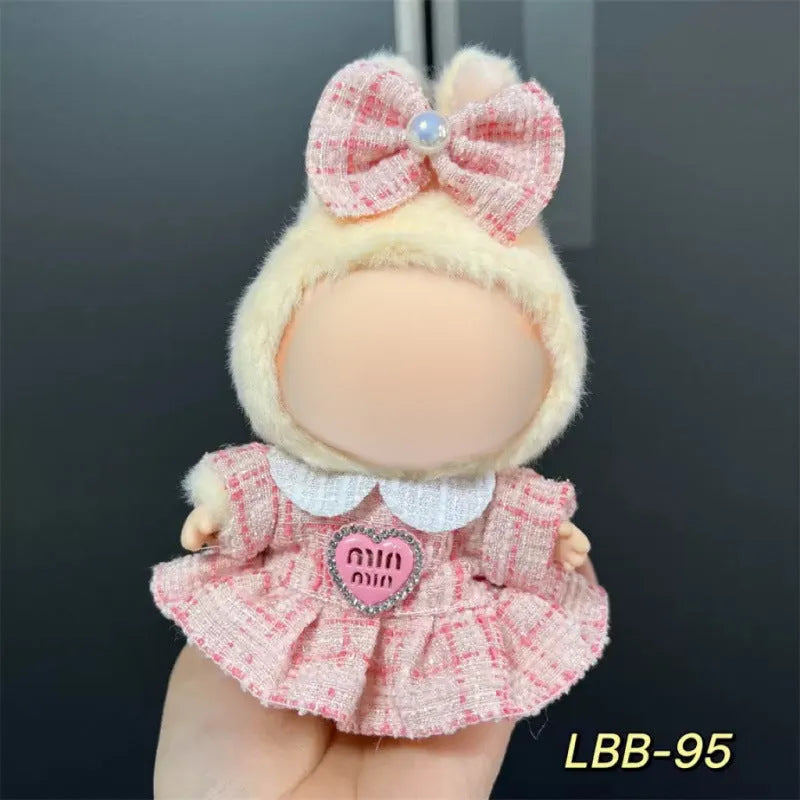 Plastic doll clothing costume for 17cm tall vinyl figurines on a display stand.