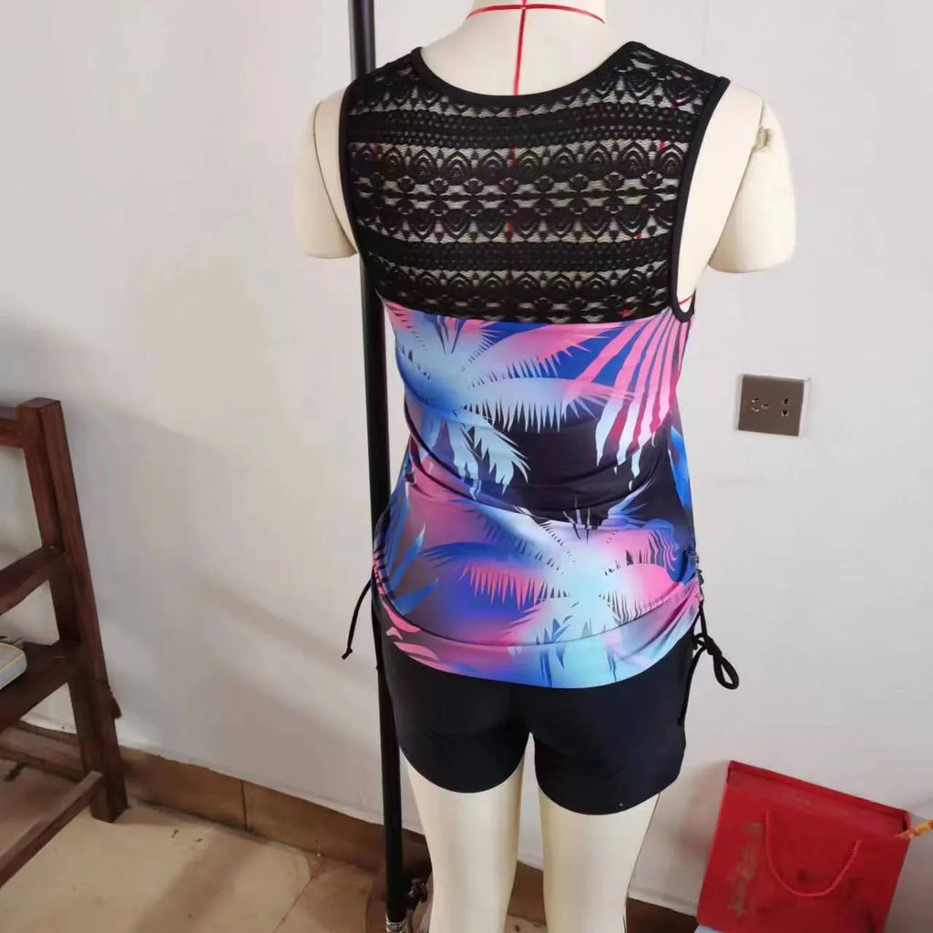 Women's blue printed lace two-piece swimsuit top and shorts laid flat.