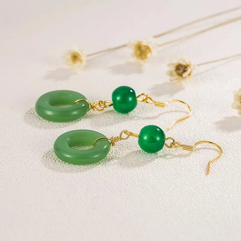 A pair of geometric green jade design Peace Buckle earrings in zinc alloy on a white background.
