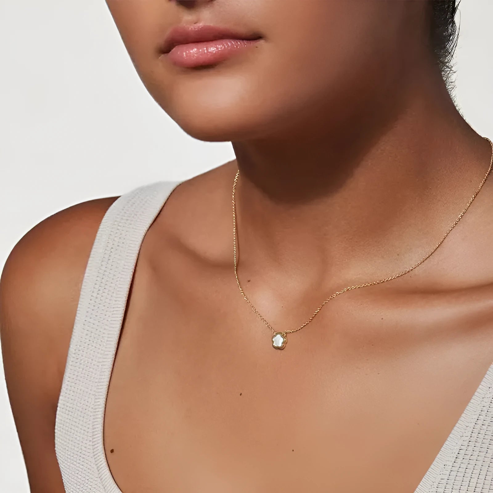 White mother shell flower necklace with floral pendant on gold or silver chain.