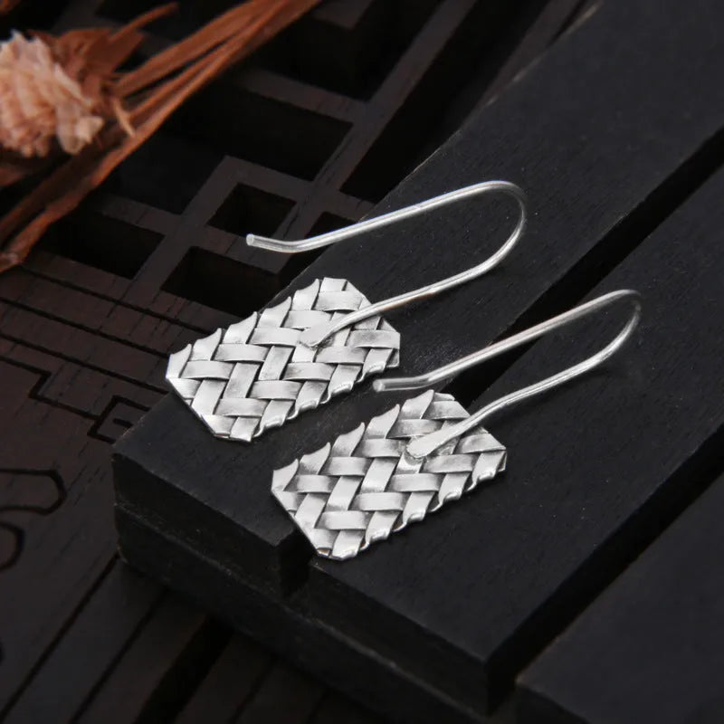 Geometric woven diamond plaid earrings in silver measuring 17.5mm by 11mm