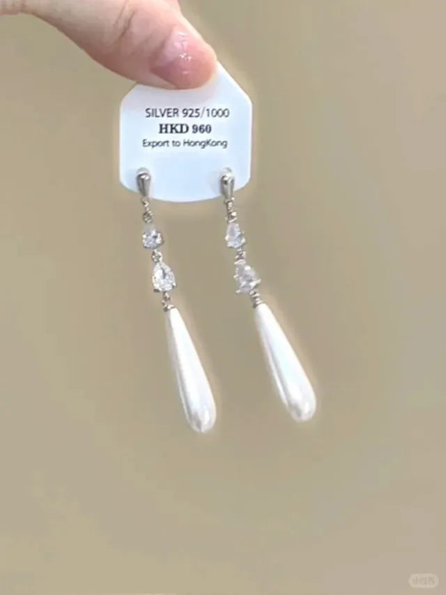 Gold heart-shaped geometric women's earrings with rhinestone stars and a tassel on the clip.