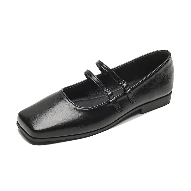 Women's silver leather Mary Jane flats with a cross buckle strap and flat sole.