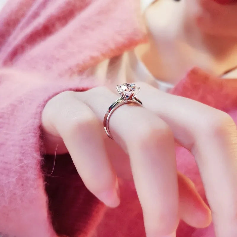 White gold plated copper ring with six-claw set zircon stone, geometric shape.