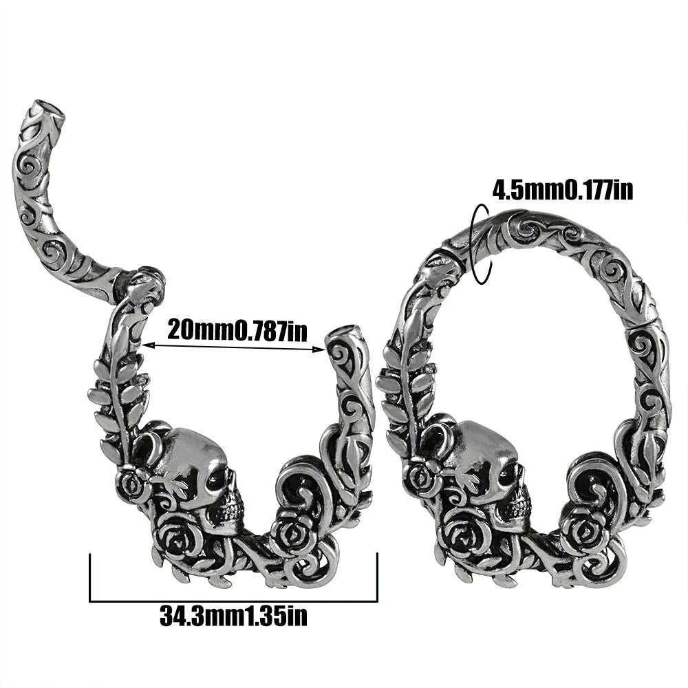 A pair of silver fashion earrings featuring a detailed totem pattern design on a stainless steel base.