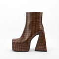 Women's artificial PU ankle boots with a super high heel in beige, shown on a foot.