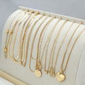 Ten gold necklaces with alloy pendants on adjustable snake bone chains in a women's jewellery set