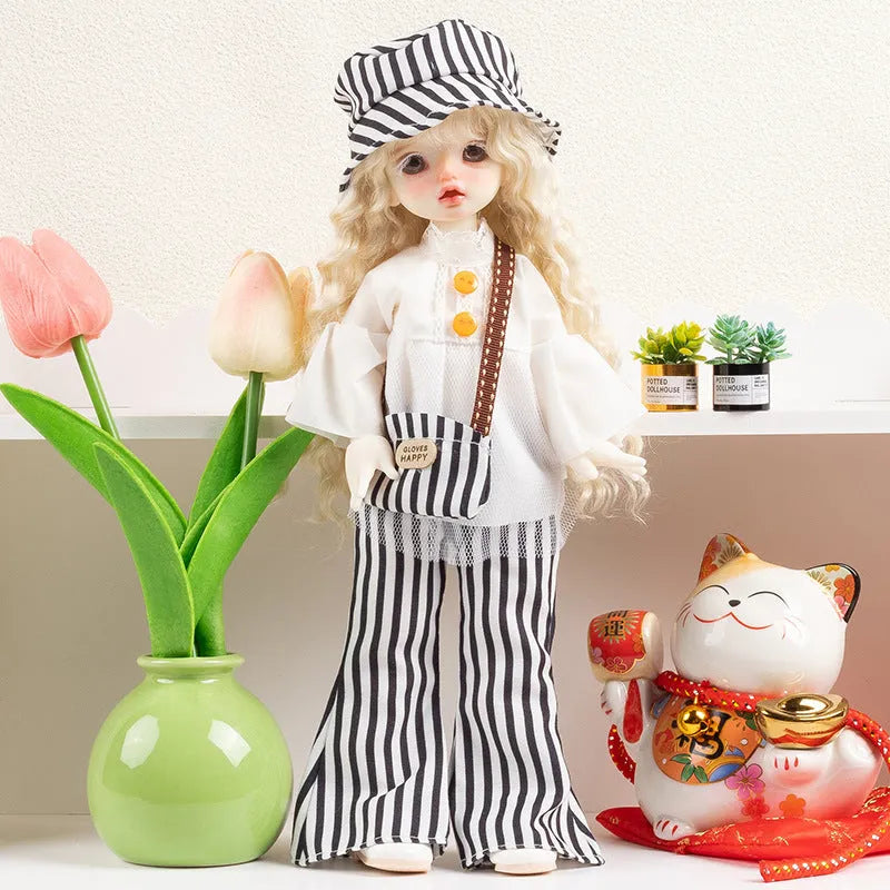Printed cloth doll clothes for fashion dolls in various colourful patterns sold separately without dolls