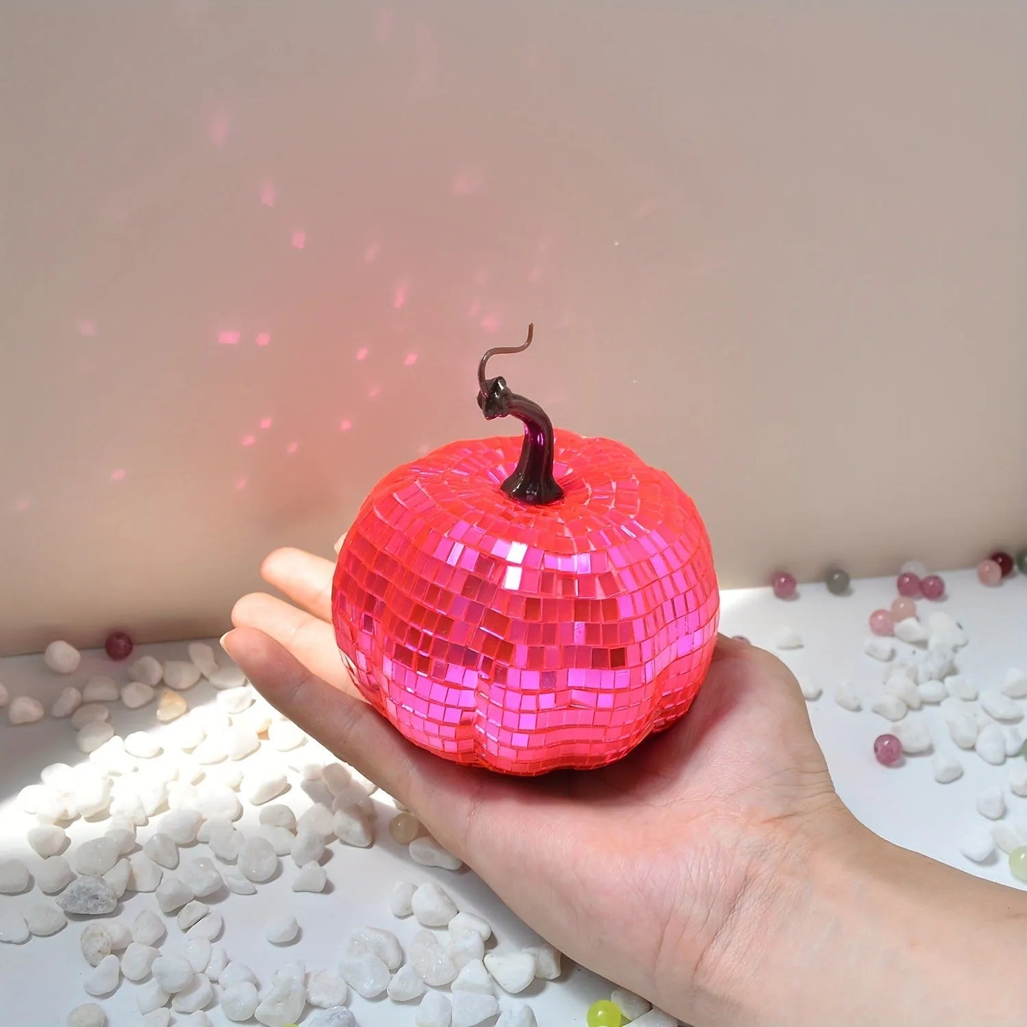 Chinese-style mirror glass pumpkin Halloween decoration in various sizes on a shelf.