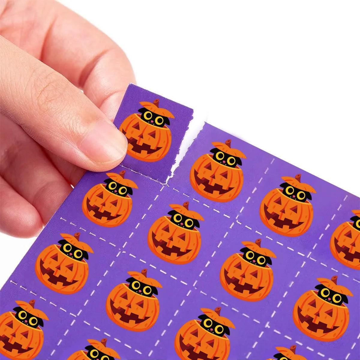 Halloween bingo game card with pumpkin design and paper nameplates on a table