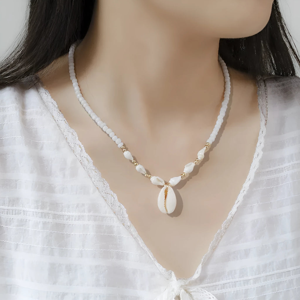 White conch shell pendant necklace on a regular chain, made from mother pearl shellfish.