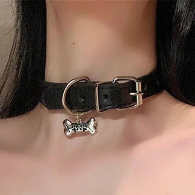 Black adjustable dog collar showing cat paw, bone, and plain leather decorative styles on a regular chain.