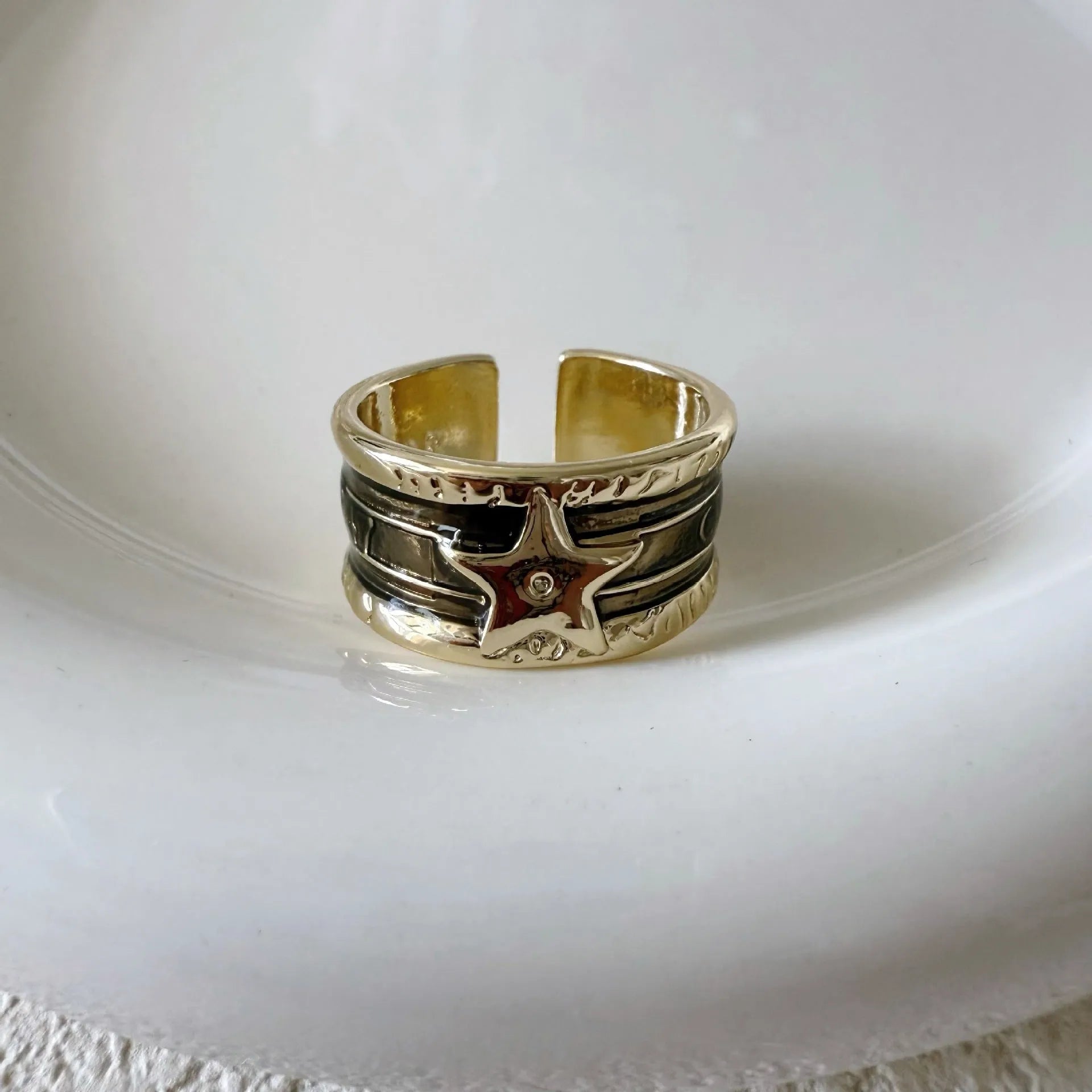 Adjustable geometric copper drop oil ring with a distressed retro finish.