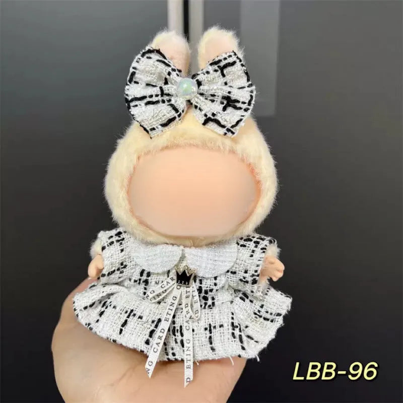 Plastic doll clothing costume for 17cm tall vinyl figurines on a display stand.