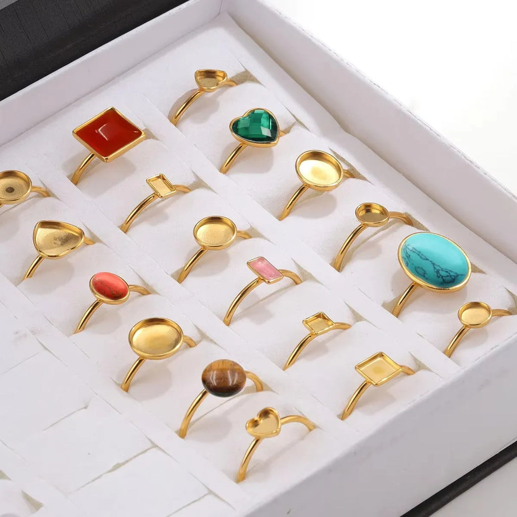 Assortment of golden electroplated stainless steel ring settings and DIY jewellery components in various shapes.