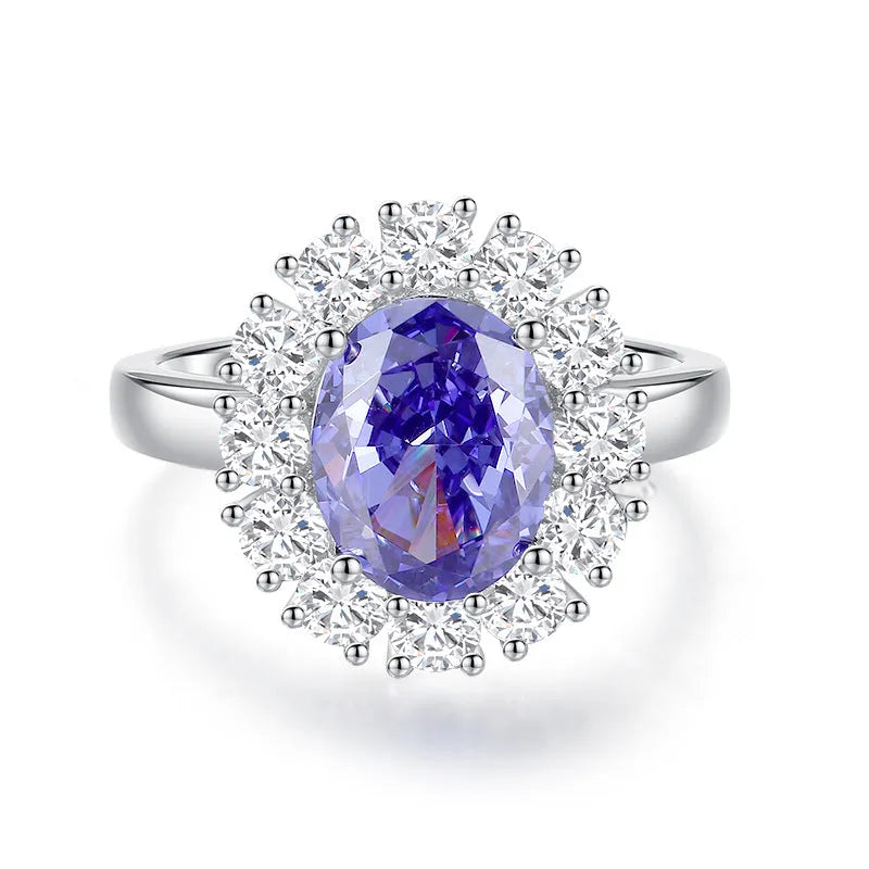 Women's heart-shaped sterling silver ring with ice flower cut coloured zircon stone on finger.