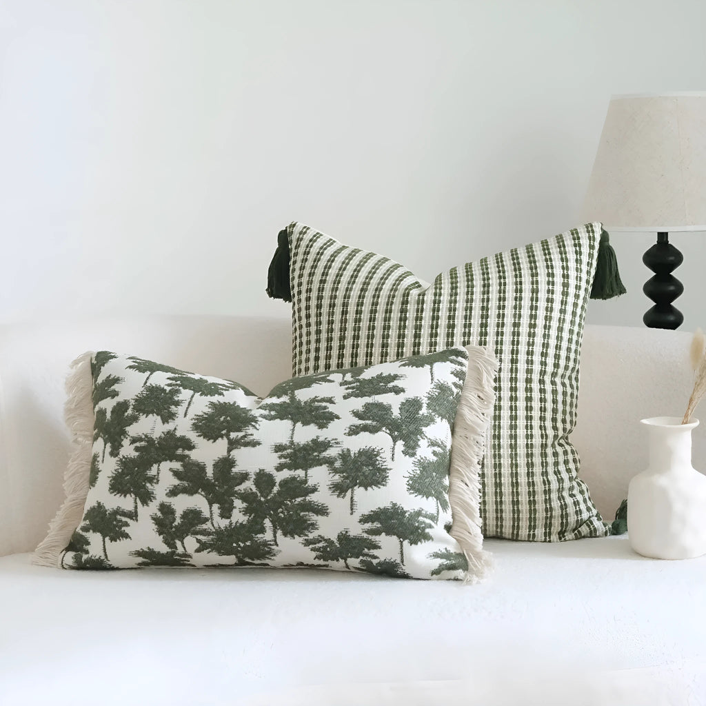 Green botanical patterned decorative pillows in striped, tree, and leaf designs on brushed cotton linen fabric