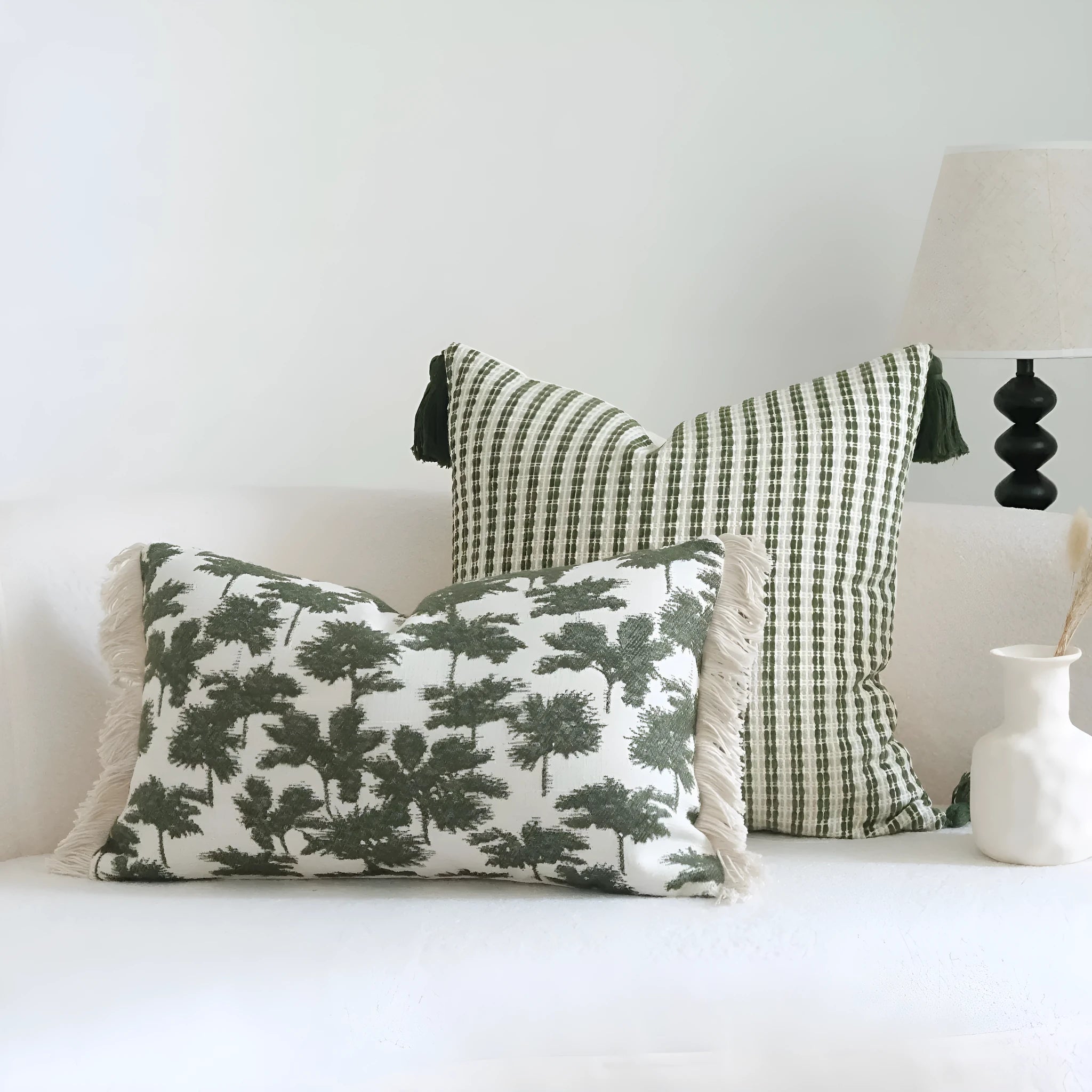 Green botanical patterned decorative pillows in striped, tree, and leaf designs on brushed cotton linen fabric