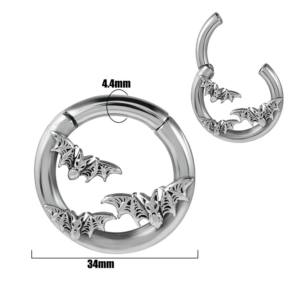 A pair of silver fashion earrings featuring a detailed totem pattern design on a stainless steel base.