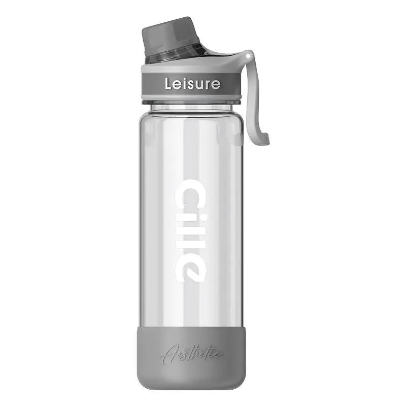 Grey plastic straw cup showing integrated straw and cylindrical shape on a table.