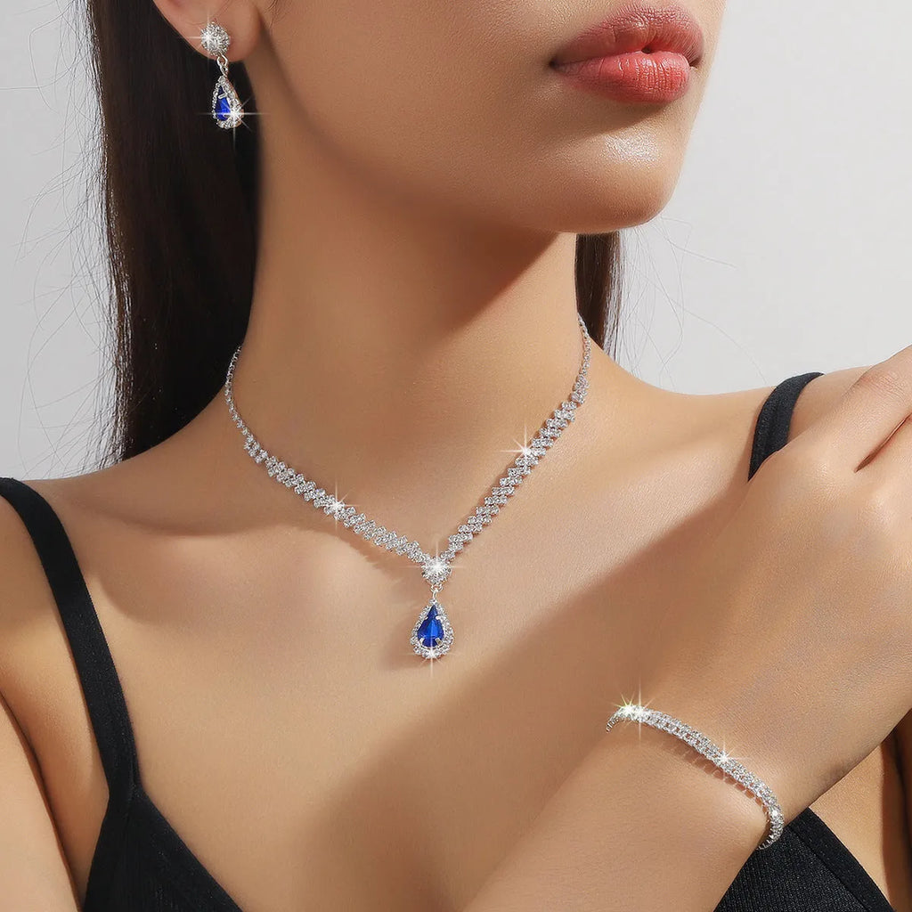 Claw chain necklace and matching earrings set with drop-shaped rhinestones in multiple colour options