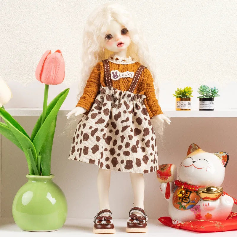 Printed cloth doll clothes for fashion dolls in various colourful patterns sold separately without dolls