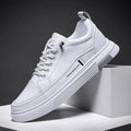 Men's white and black low-top skateboard shoes with elastic band fastening and rubber sole.