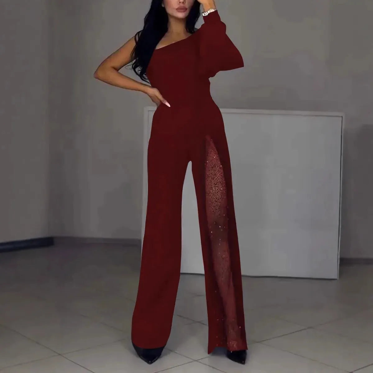 Women's black polyester jumpsuit with oblique shoulder neckline and high slit leg detailing