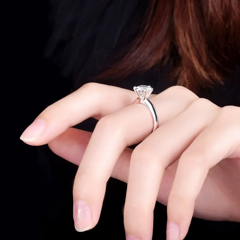 White gold plated copper ring with six-claw set zircon stone, geometric shape.