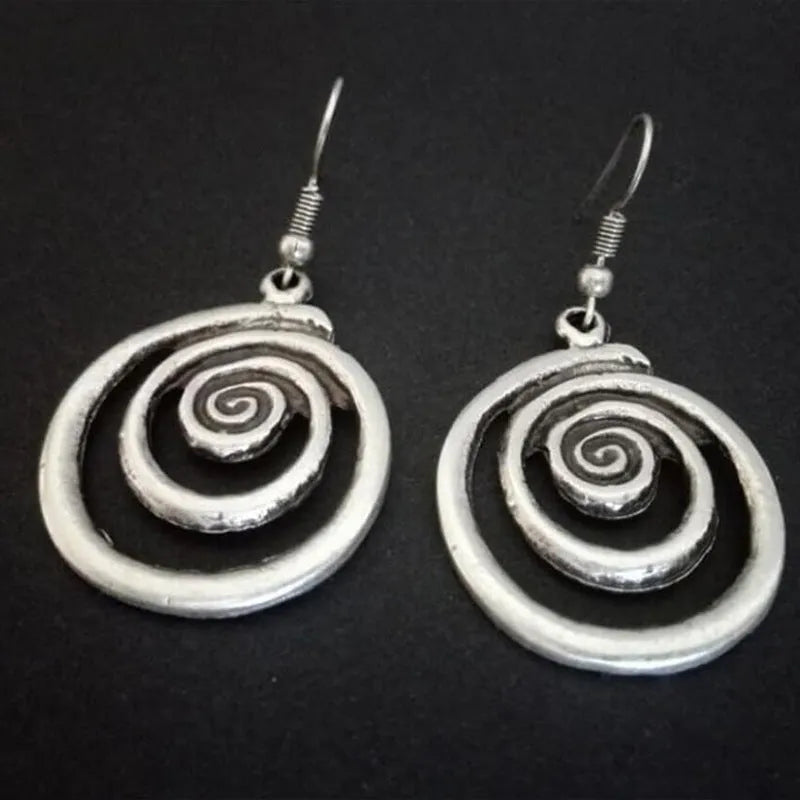 Geometric spiral distressed silver earrings measuring 2.6cm by 5cm with unisex design