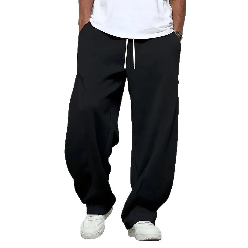 Men's solid-colour casual trousers with a drawstring waist in a straight-leg style.