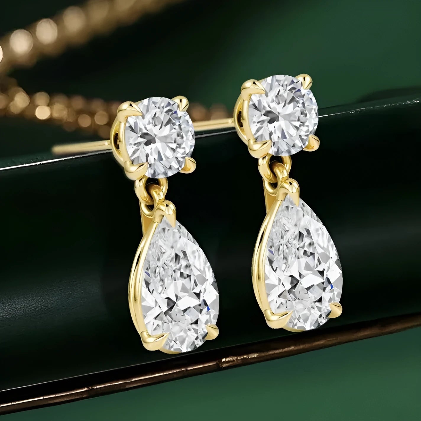 Women's sterling silver geometric stud earrings with round and water drop moissanite stones.