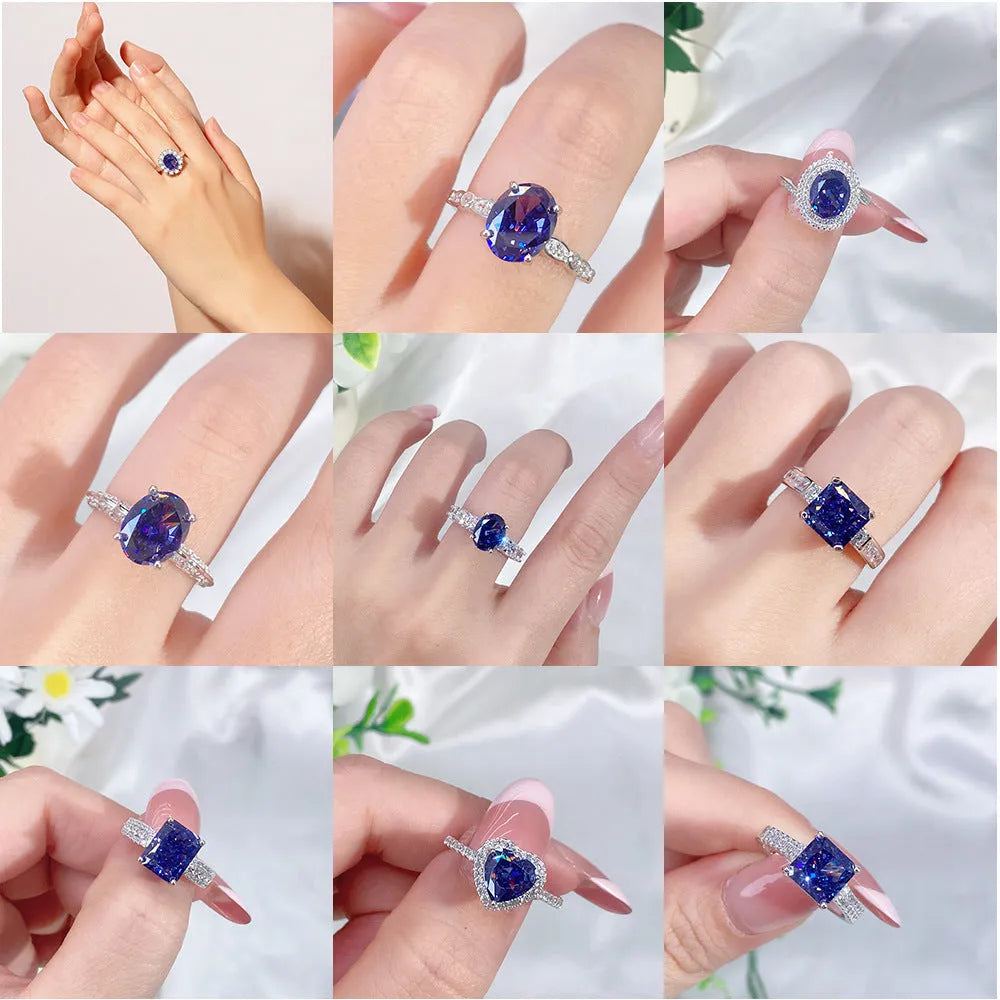 Women's heart-shaped sterling silver ring with ice flower cut coloured zircon stone on finger.
