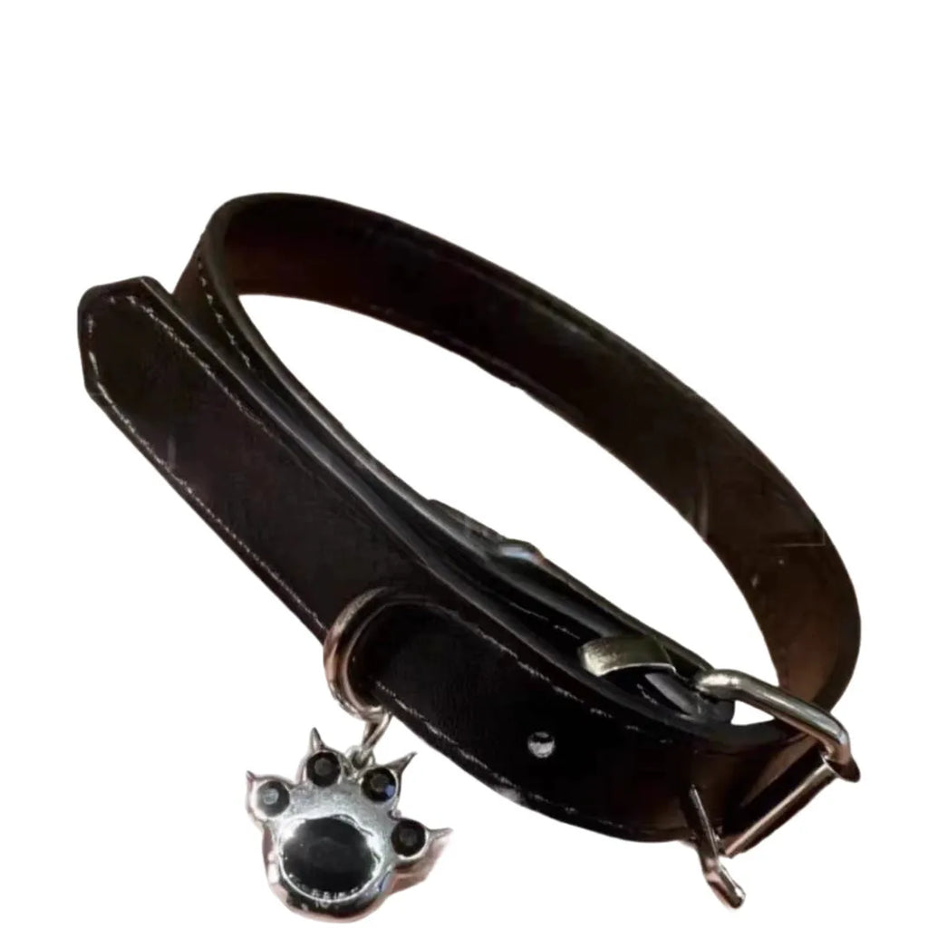Black adjustable dog collar showing cat paw, bone, and plain leather decorative styles on a regular chain.