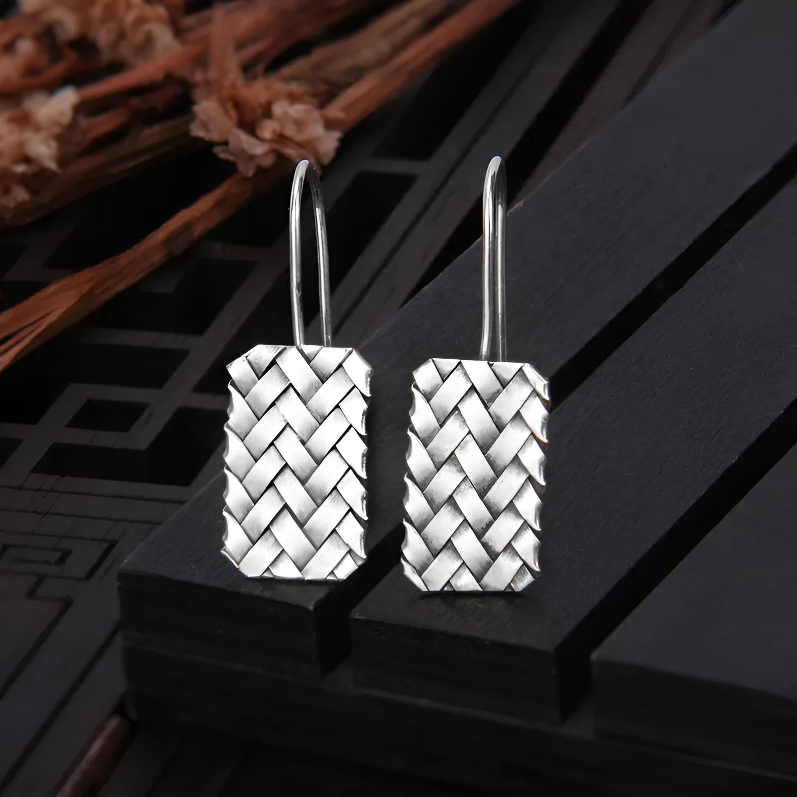 Geometric woven diamond plaid earrings in silver measuring 17.5mm by 11mm