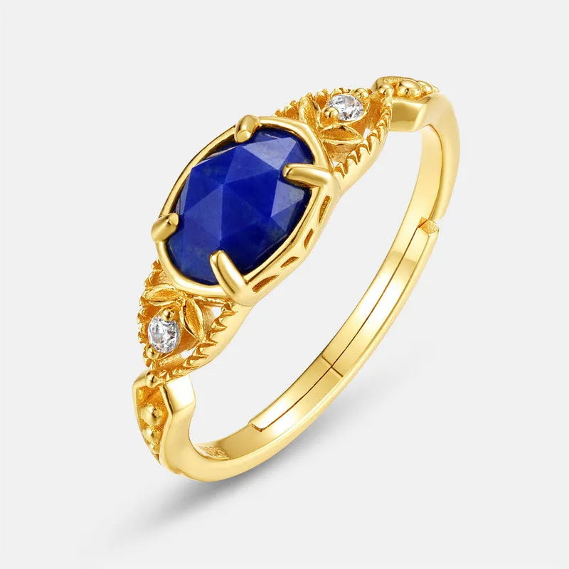 Japanese style silver alloy ring with a deep blue lapis lazuli stone in an elliptical geometric setting.