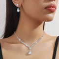 Claw chain necklace and matching earrings set with drop-shaped rhinestones in multiple colour options