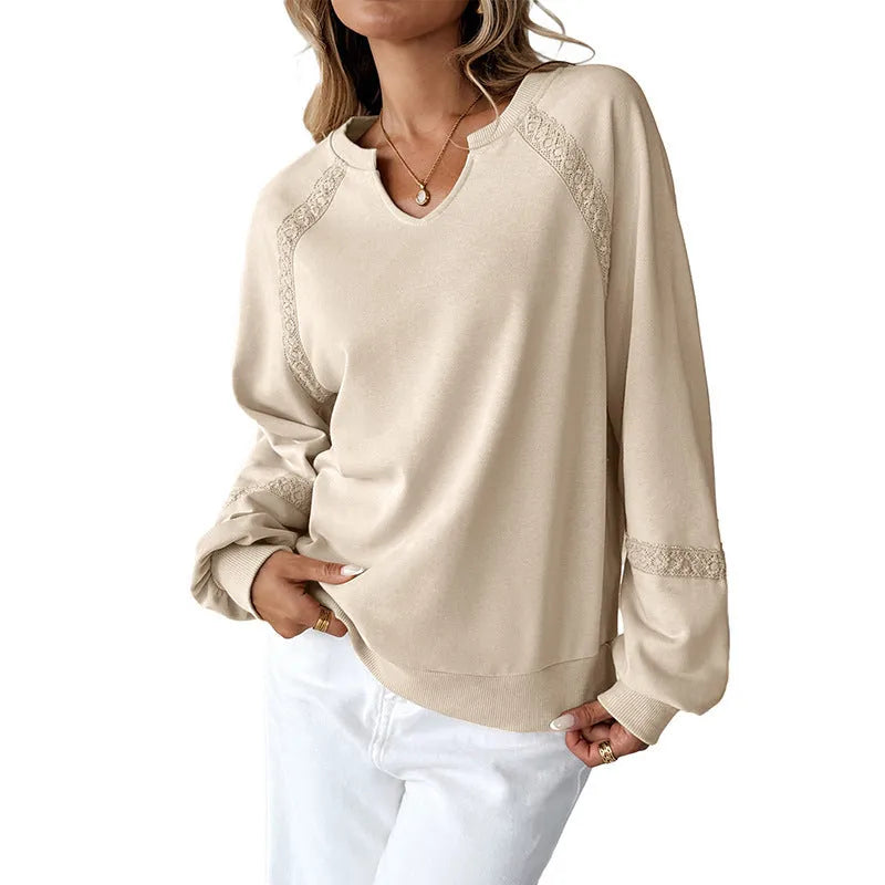 Women's loose-fitting long sleeve sweater with lace trim and a half-open collar in a solid colour.
