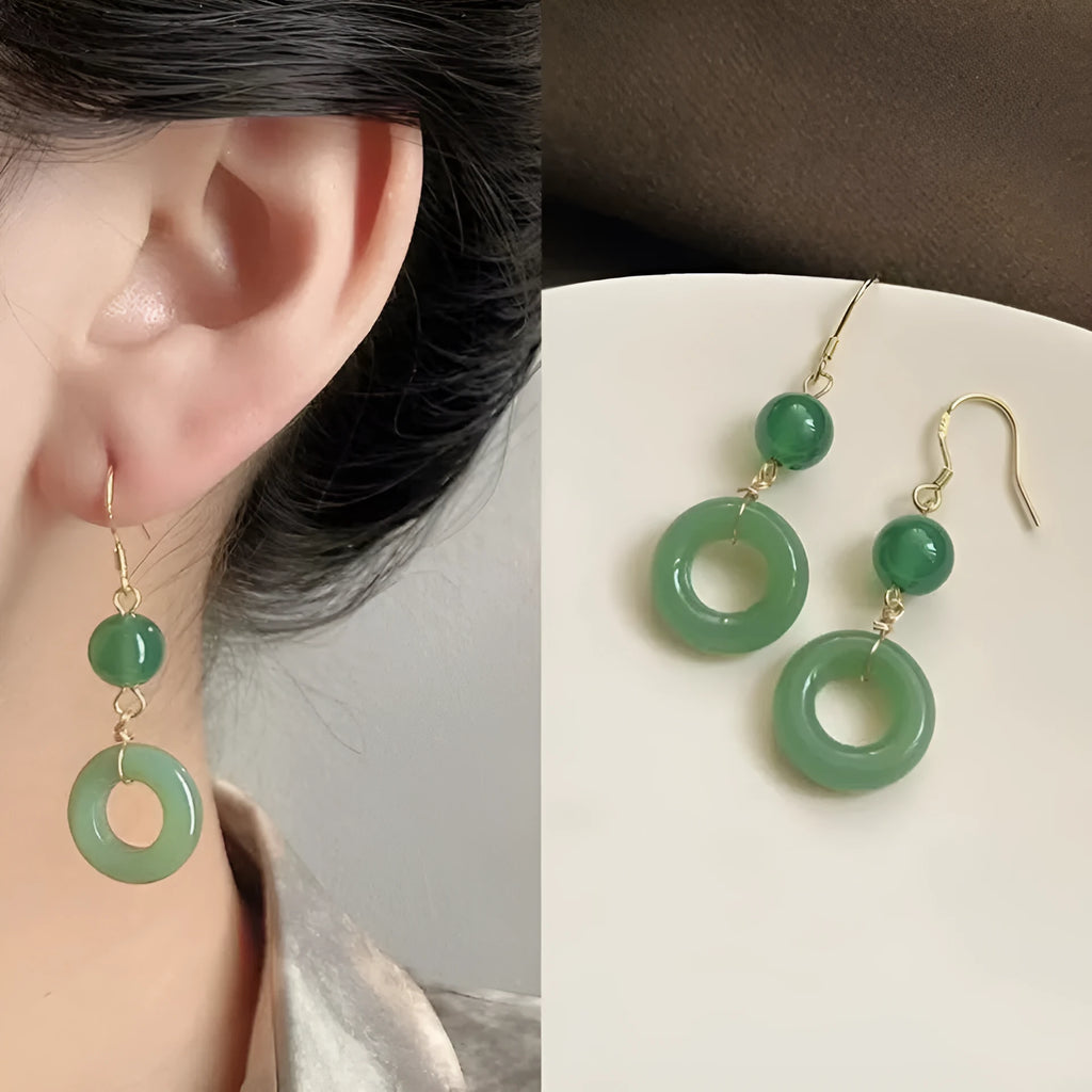 A pair of geometric green jade design Peace Buckle earrings in zinc alloy on a white background.