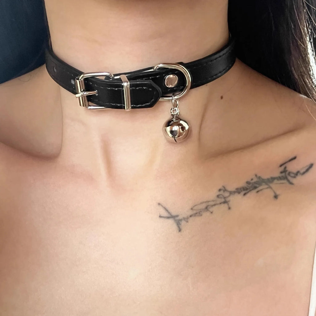 Black adjustable dog collar showing cat paw, bone, and plain leather decorative styles on a regular chain.