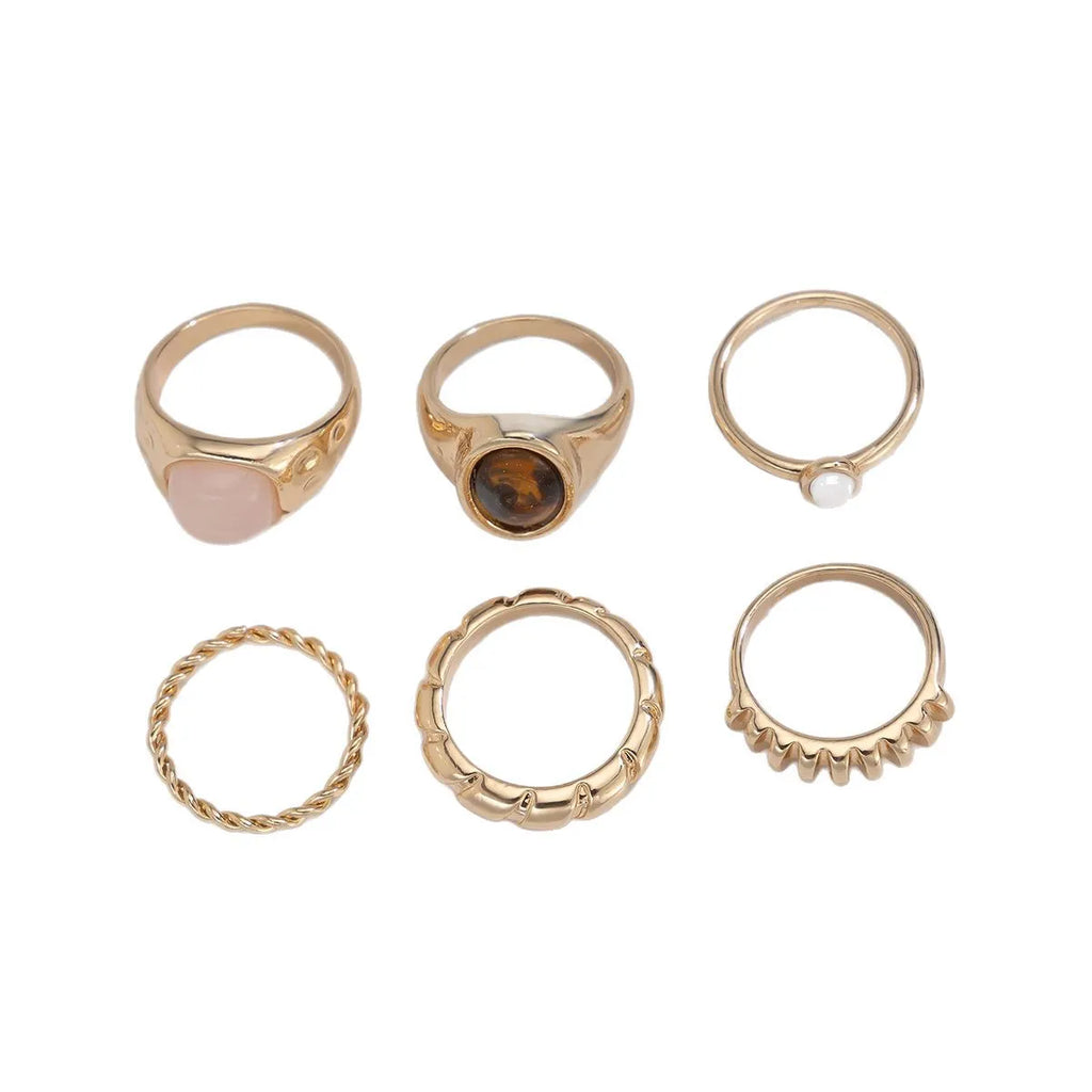 Six geometric light gold alloy rings arranged in set with electroplated finish